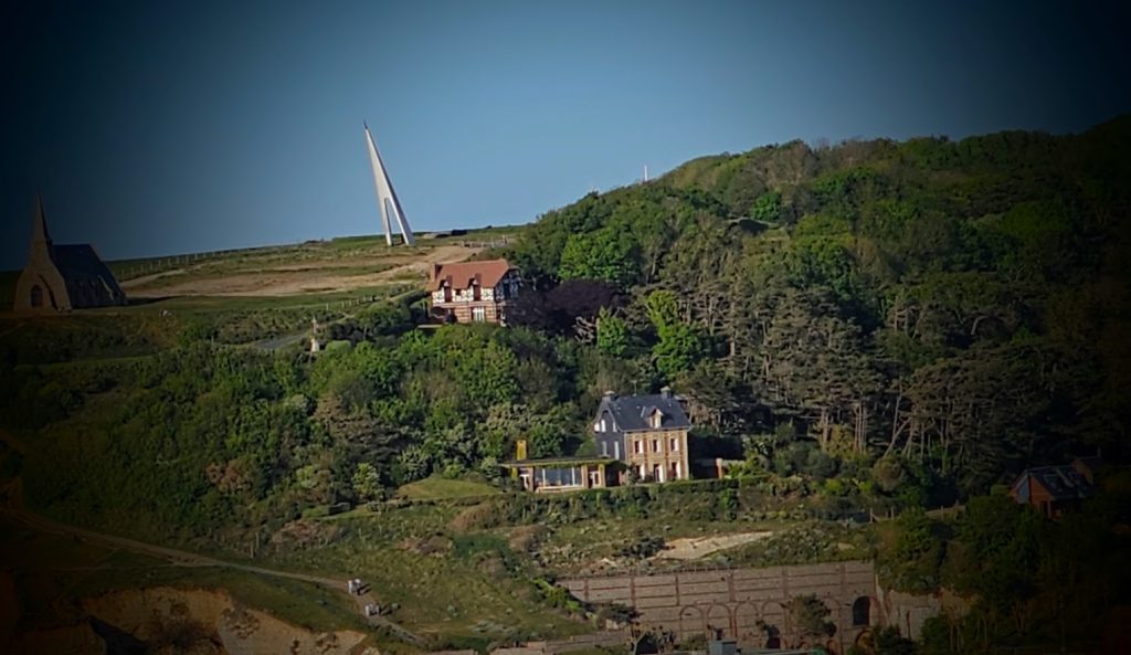 Jardins d'Étretat, na Normandia, com esculturas vegetais e vista para as falésias.